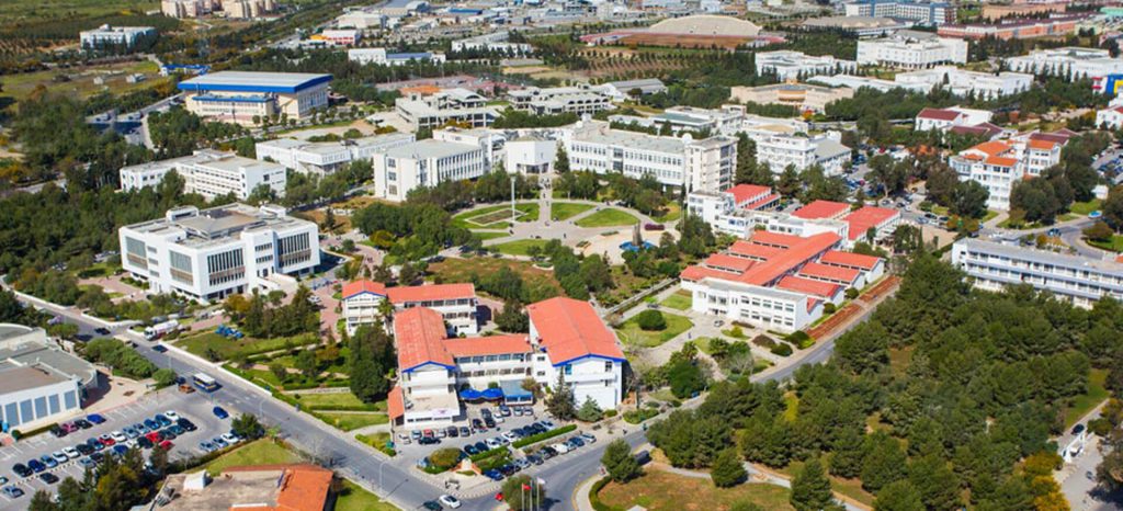 Aerial view of Eastern Mediterranean University campus in North Cyprus, showing academic buildings, green spaces, and modern educational facilities.