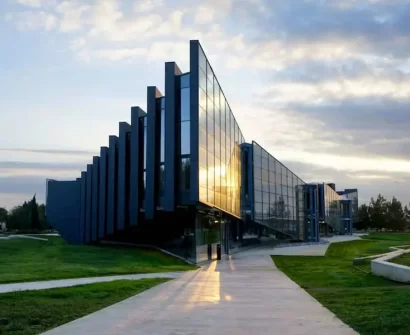 Modern glass building of the Faculty of Science and Technology at Cyprus International University (CIU) in North Cyprus during sunset.